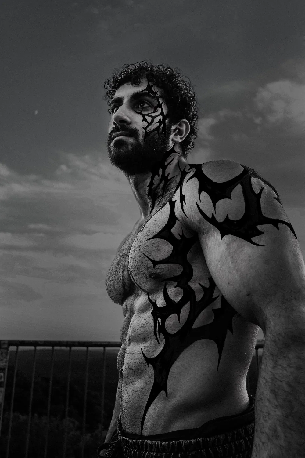 Black and white body-paint editorial portrait.